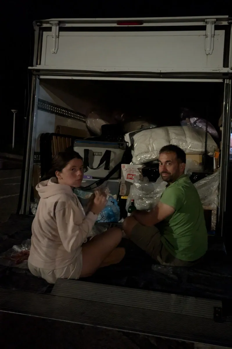 Gemma e cristian dining on the van fold-down tailgate