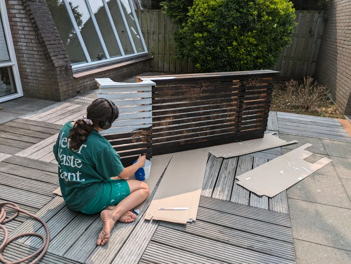 Sophia paints the radiator cover in her room